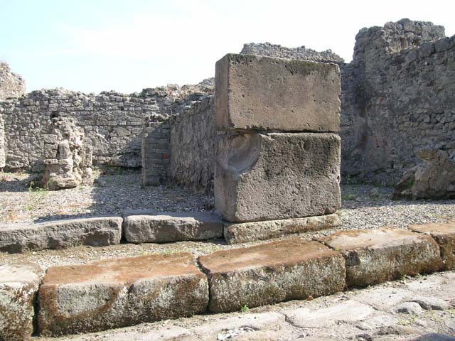 VII.9.50 Pompeii.  December 2005. Looking south across shop, to two rear rooms. According to Fiorelli, the shop had a counter with a simple hearth and at the rear were two rooms, one with the usual staircase.  See Pappalardo, U., 2001. La Descrizione di Pompei per Giuseppe Fiorelli (1875). Napoli: Massa Editore.(p107)  According to Liselotte Eschebach, to the left was a rear room with a hearth, and a downpipe from latrine on upper floor. To the right was another room with a staircase to the upper floor.  See Eschebach, L., 1993. Gebäudeverzeichnis und Stadtplan der antiken Stadt Pompeji. Köln: Böhlau. (p317)
