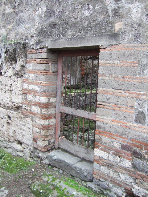 VII.10.8 Pompeii. December 2005. Hearth or bench on east side of doorway in kitchen area.