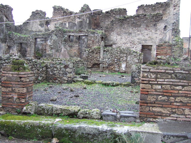 VII.10.10 Pompeii. December 2007. Looking west across shop towards doorway to rear room.