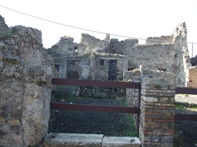 VII.10.12 Pompeii. December 2005. Looking west across shop towards doorway to atrium of dwelling.