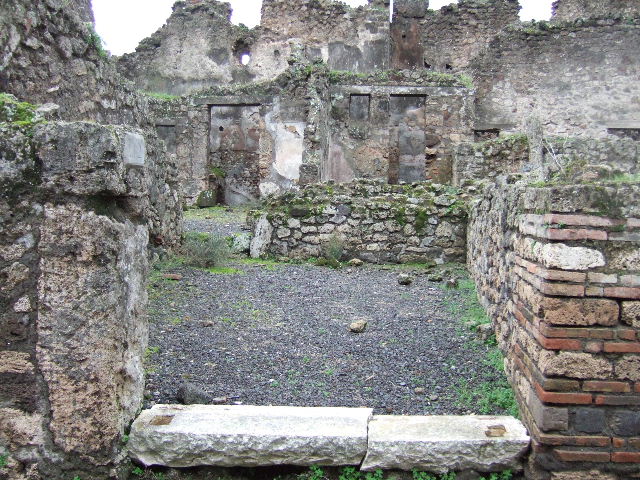 VII.10.12 Pompeii. March 2009. Looking east towards remains of a cubiculum, and the front of the shop.