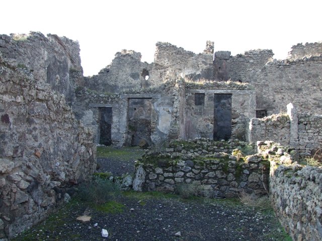 VII.10.12 Pompeii. March 2009. West side of atrium, with doorways to Latrine and Kitchen (VII.10.9)