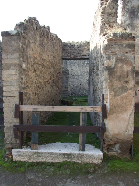 VII.11.14 Pompeii. March 2009. Room 1, passageway, with doorway to entrance corridor and stone at base of staircase.