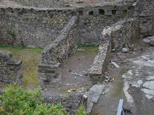 VII.16.a Pompeii. May 2010. Site of cippus of Suedius Clemens in roadway, against exterior wall of lower rooms.