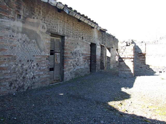 VIII.5.37 Pompeii.  March 2009.  South side of Podium of Lararium, with remains of painted plant decoration.
