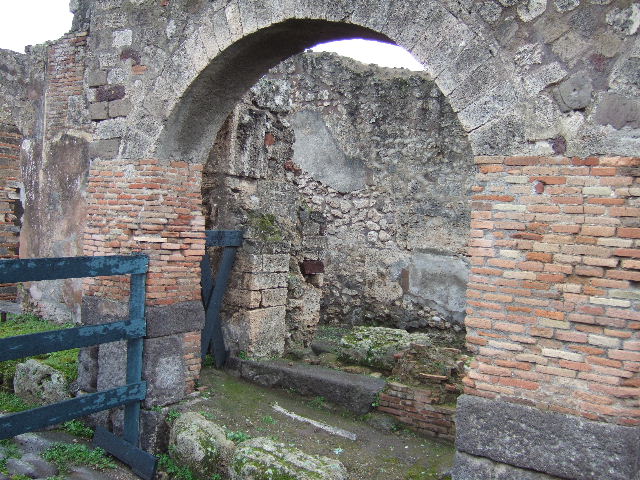IX.2.28 Pompeii. December 2005. Looking east from IX.2.1, towards kitchen, latrine and storeroom, and through doorway to porticus of IX.2.27.
