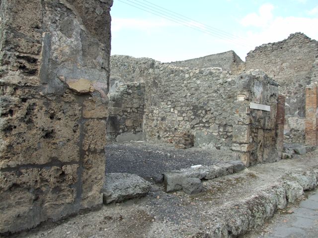 IX.3.17 Pompeii. March 2009. West side of workshop. Remains of bench with water basin.