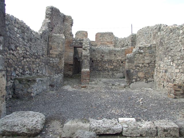 IX.3.17 Pompeii. March 2009. West side of workshop. Remains of bench with water basin.