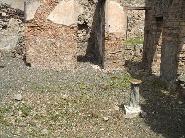 IX.6.3 Pompeii. May 2005. Looking south along small garden area to large triclinium, on south side. According to Jashemski, this small open area at the rear of this small house was visible from the entrance through a window at the rear of the atrium (on right of photo between the doorways). Attached to the wall on the east side were 3 steps which in the middle had a small basin the height of the lowest 2 steps.  The passageways around the open area were roofed by the overhang of the adjacent rooms. See Jashemski, W. F., 1993. The Gardens of Pompeii, Volume II: Appendices. New York: Caratzas. (p.238)
