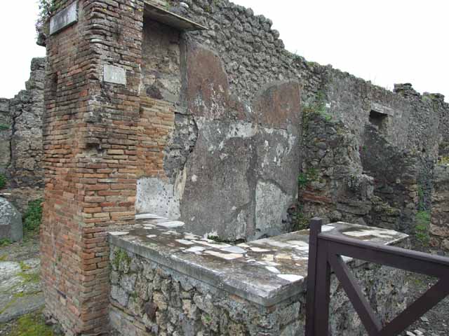IX.9.8 Pompeii. May 2010. East wall behind counter.