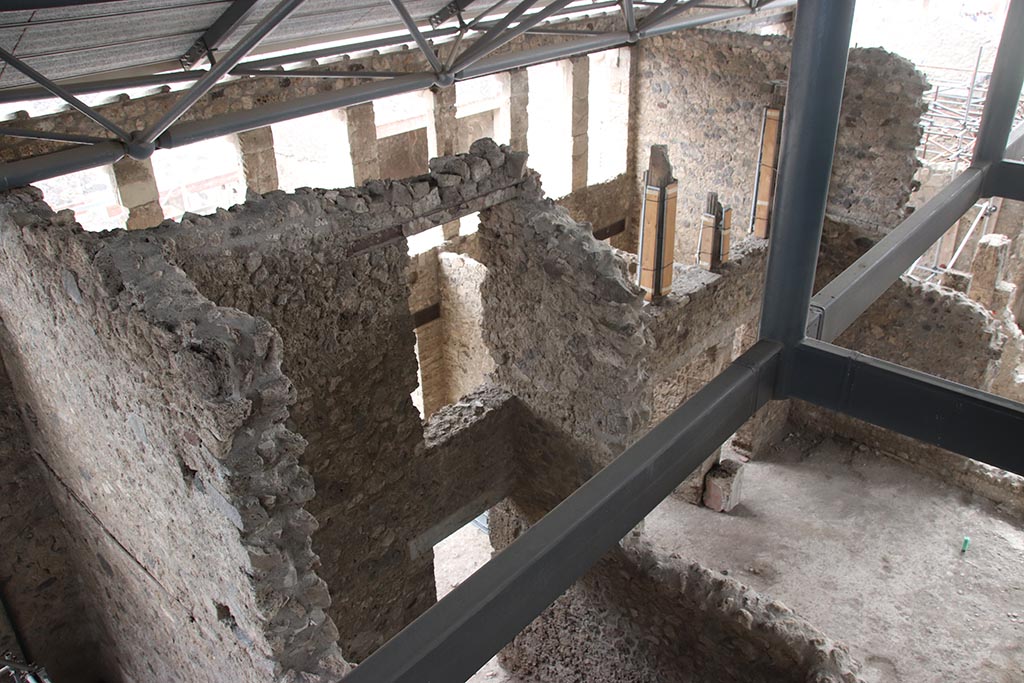 IX.12.5 Pompeii. October 2024. Looking south-west from above rear room “h”, through doorway into shop-area “i”.
O the right is the atrium of IX.12.4. Photo courtesy of Klaus Heese.