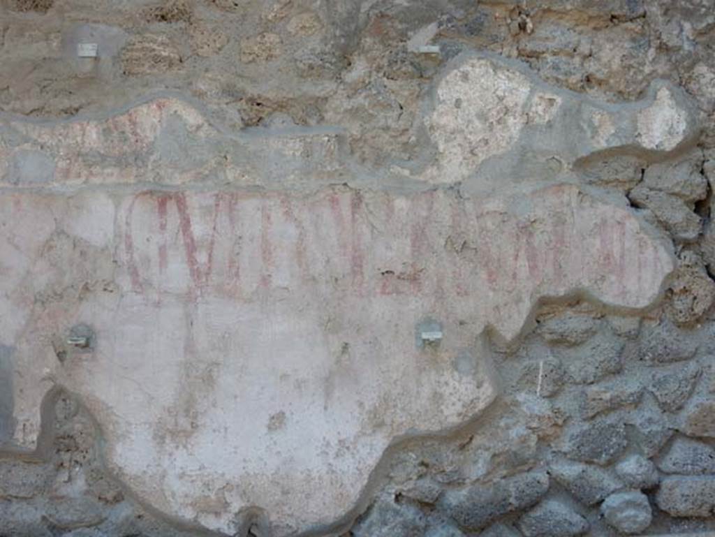IX.12.7 Pompeii. May 2017. Detail of remaining graffiti on east side of panel, below window opening between IX.12.6 and IX.12.7. Photo courtesy of Buzz Ferebee.