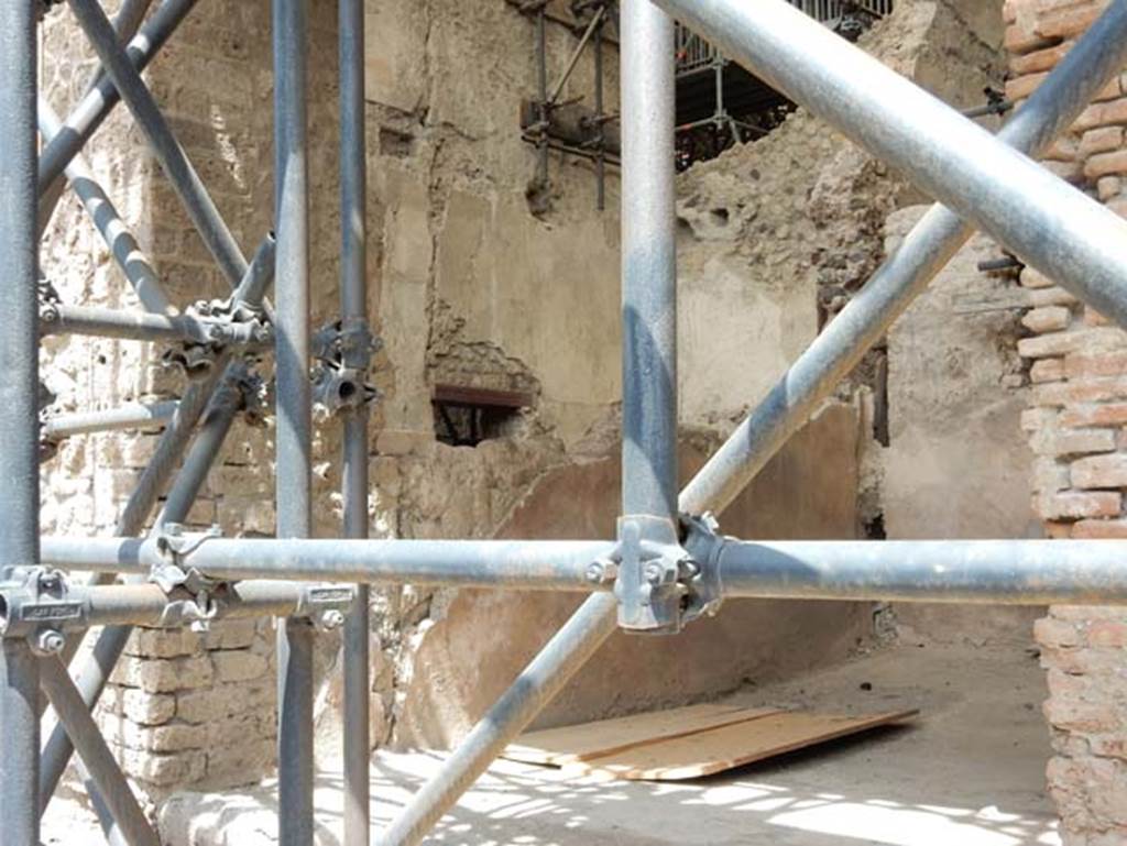 IX.12.7 Pompeii, May 2018.
Looking towards west wall of shop-room 1, at the left rear of the wall is room “c2” of IX.12.6 with doorway. Photo courtesy of Buzz Ferebee.