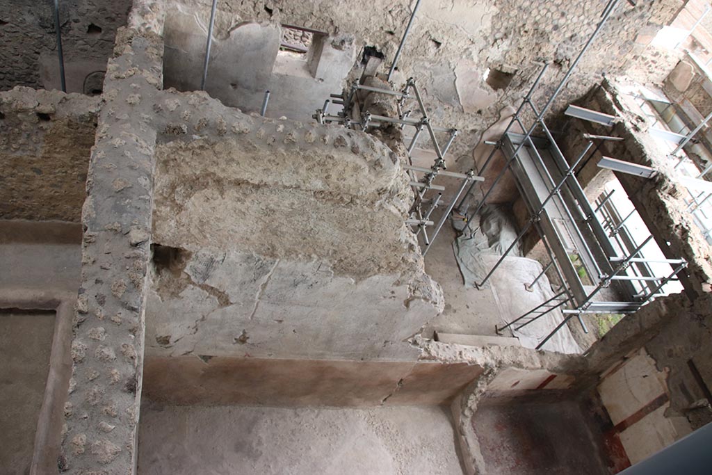 IX.12.7/6 Pompeii. October 2024.
Looking east from above room “c2” of IX.12.6, lower centre left, towards shop-room and rear room of IX.12.7. Photo courtesy of Klaus Heese.