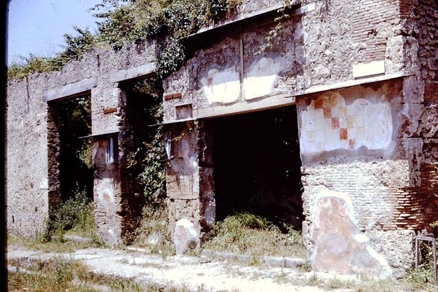IX.13.5 Pompeii. Graffito found on east (right) side of entrance doorway.  Fullones ululamque cano non arma virumq(ue)       [CIL IV 9131]
According to Cooley, a graffito was found on the façade near the picture of Aeneas – Fullones ululamque cano, non arma virumque    [CIL IV 9131]  She translated it as –  “I sing of fullers and an owl, not of arms and a man”    She said that this graffito had been modified from the famous opening words of the Aeneid, well-known by and often quoted by the Pompeians.  The original was written as “arma virumque cano” (translation – I sing of arms and a man).  The owl was a symbol of fullers, because of its link with their patroness, Minerva.  The parody also puns on the fuller’s name (ululam cano).
See Cooley, A. and M.G.L., 2004. Pompeii : A Sourcebook. London : Routledge. (p.71-2)
See also Garcia y Garcia, L., 2005. Pupils, Teachers and Schools in Pompeii. Roma: Bardi editore. (p.142)
