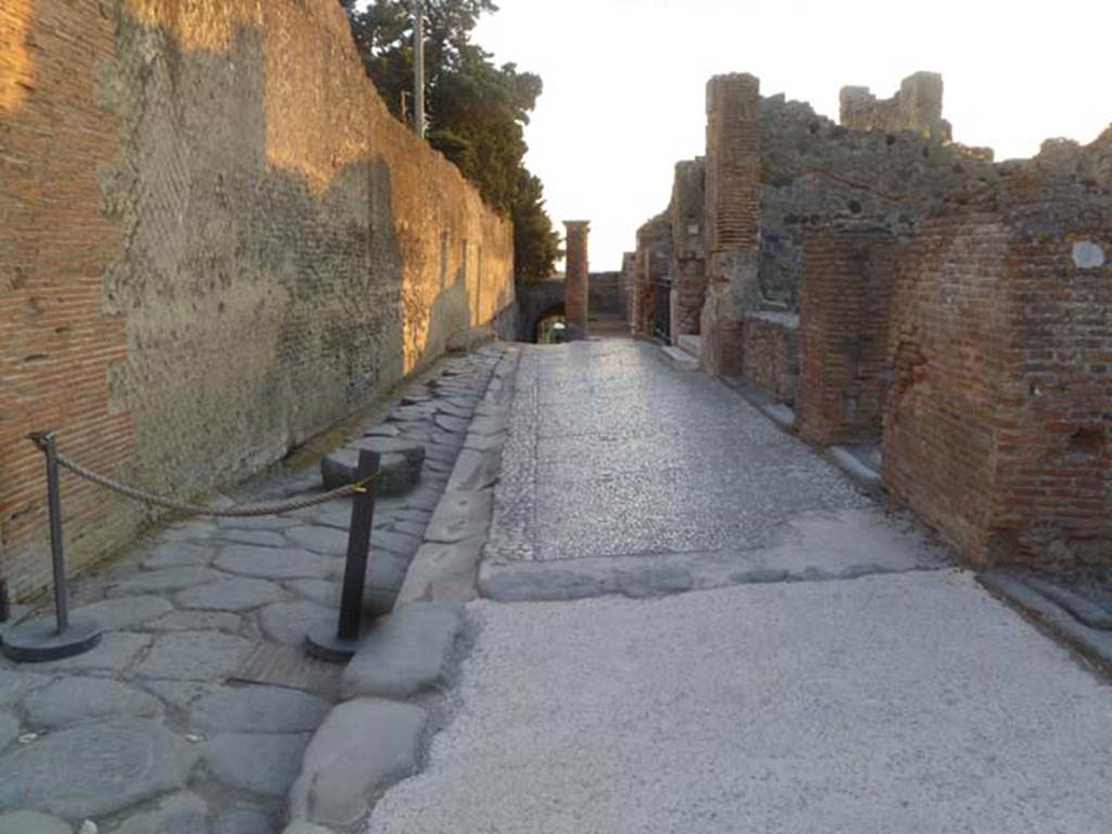 Via Marina, May 2011. Looking west with the wall of the Temple of Venus (on left), and VII.7.7-10 (on right). Photo courtesy of Michael Binns. 
