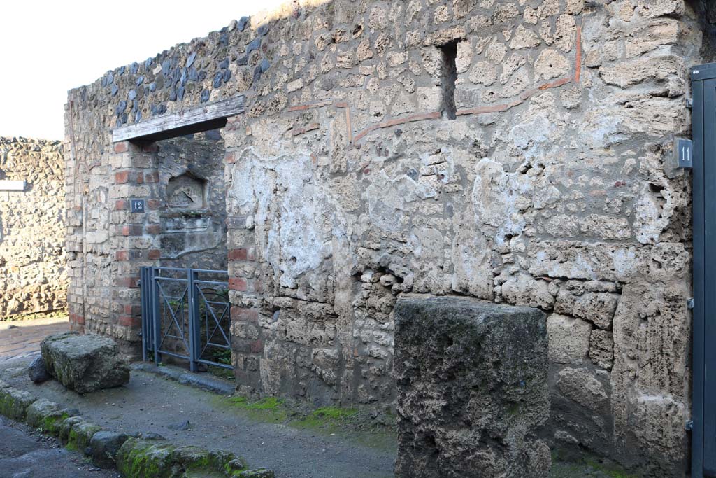 Via di Castricio, north side, Pompeii. December 2018. 
Entrance doorway of I.12.12 on east side of junction with Vicolo della Nave Europa, on left. Photo courtesy of Aude Durand.
