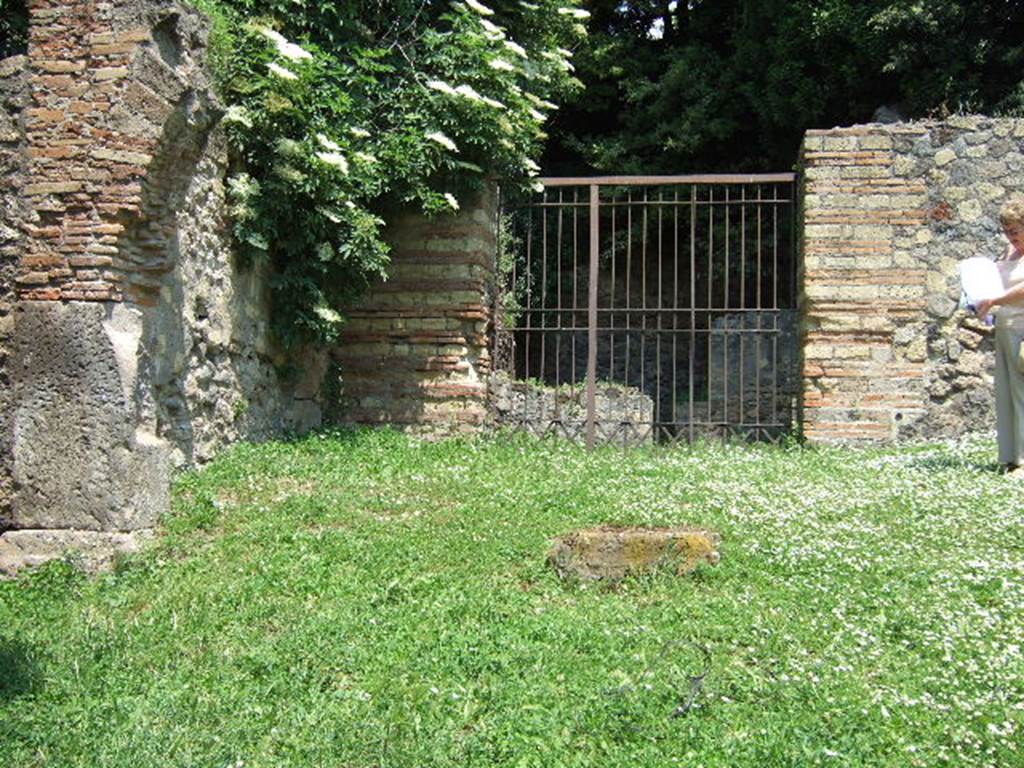 HGE29 Pompeii. May 2006. Looking east to entrance doorway to rooms 1 and 2.
According to Mau, a potters workshop with two ovens was located here. The ovens which were not large, had an upper division in which were placed the vessels to be baked. Beneath this was a firebox, underneath the floor above being pierced with holes to let the heat through. The vault of one of the ovens was constructed of parallel rows of jars fitted into one another. See Mau, A., 1907, translated by Kelsey, F. W., Pompeii: Its Life and Art. New York: Macmillan. (p. 386).
According to Garcia y Garcia, a bomb fell during the night of 18th September 1943 thoroughly hitting the workshop. This destroyed the two rooms, 29 and 30,  with their respective ovens. See Garcia y Garcia, L., 2006. Danni di guerra a Pompei. Rome: LErma di Bretschneider. (p.163)
