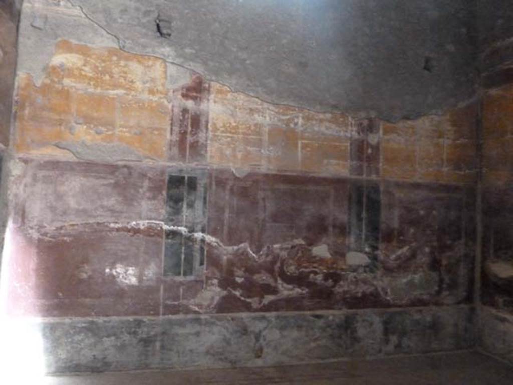 Oplontis, September 2015. Room 18, north wall. The walls had a black background at the bottom (the zoccolo), with red in the middle forming large panels with vignettes of painted birds pecking at fruit.
