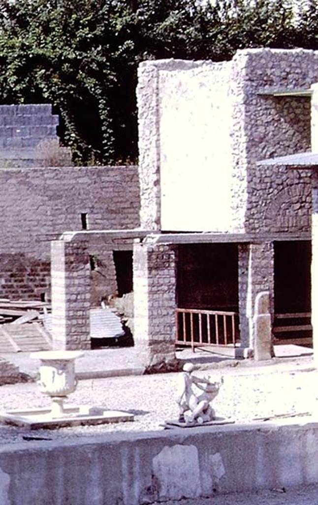 Oplontis Villa of Poppea, 1978. Room 84 is behind the pillars, at the east end of area 91, at the south end of the swimming pool 95. 
Detail from photo by Stanley A. Jashemski.   
Source: The Wilhelmina and Stanley A. Jashemski archive in the University of Maryland Library, Special Collections (See collection page) and made available under the Creative Commons Attribution-Non Commercial License v.4. See Licence and use details.
J78f0045
