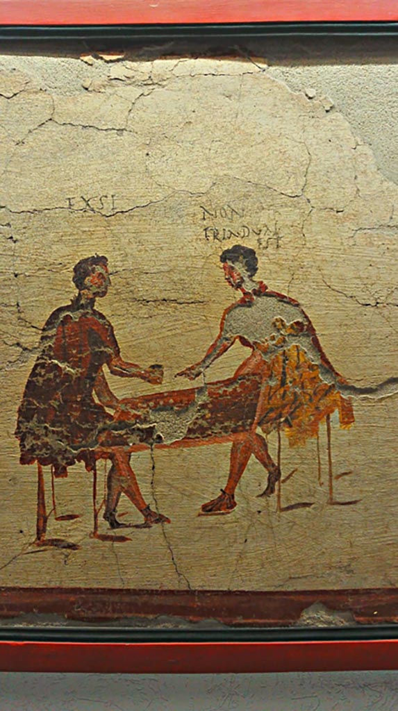 VI.14.35/36 Pompeii. June 2017. Fresco of a scene of gambling, from the north wall.
On display in Naples Archaeological Museum, photo courtesy of Giuseppe Ciaramella.