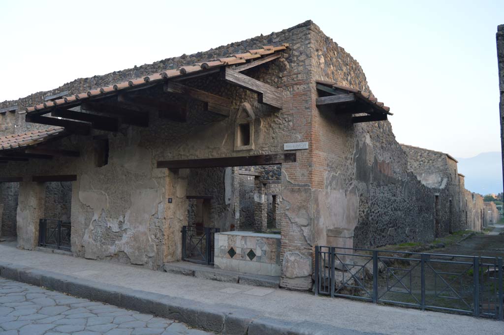 Via dell’Abbondanza, south side, Pompeii. October 2017. 
Looking south-east towards entrance doorway of I.11.1, in centre, and street altar in small roadway, on right.
Foto Taylor Lauritsen, ERC Grant 681269 DÉCOR.
