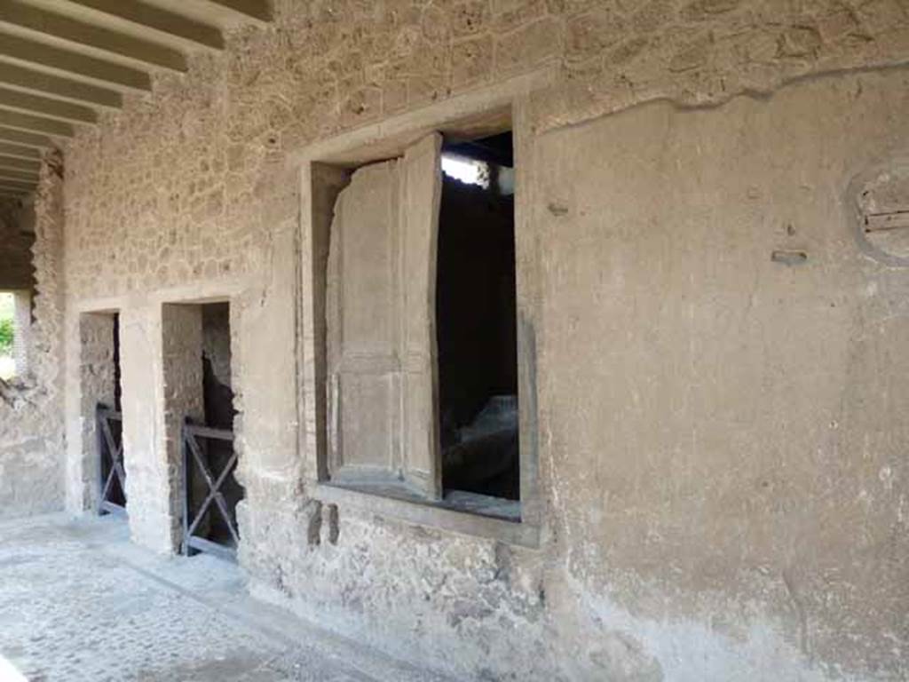 Villa of Mysteries, Pompeii. May 2010. Looking north along portico P3, with doorways to rooms 13 and 12 and shuttered window of room 11.