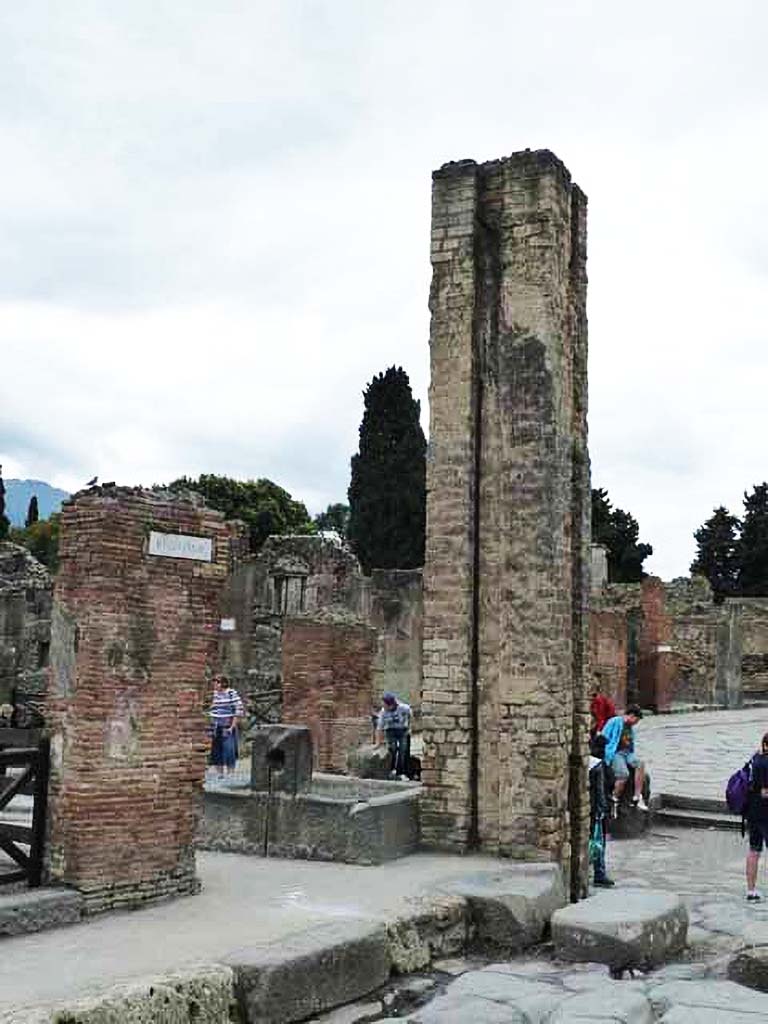 Fountain outside I.4.15 on Via Stabiana. May 2010. 
North and east sides of fountain and water column on the south side of the Via dellAbbondanza, at the junction with Via Stabiana. 

