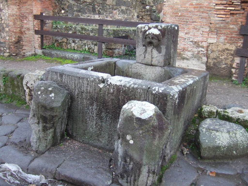 Fountain outside VII.1.32 and VII.1.33, December 2005. Looking south-west.
According to Eschebach, opposite the fountain was the street shrine of the lares compitales. See Eschebach, L., 1993. Gebudeverzeichnis und Stadtplan der antiken Stadt Pompeji. Kln: Bhlau. (p.249)
 
