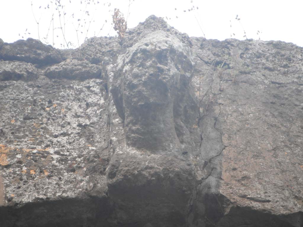 Nola Gate, Pompeii. May 2011. Head of Minerva on city side (west side) of Nola Gate. Photo courtesy of Ivo van der Graaff.
According to Van der Graaff –
“Perhaps the most recognized religious symbol on the Pompeian fortifications is the keystone on the city side of the Porta Nola (see Fig. 8.1).
………………………. Although weathering has damaged the bust almost beyond recognition, a few identifiable locks of curled hair and the base of a helmet on the neck identify her as Minerva. Presumably, such busts decorated more than just one of the gates at Pompeii, but no others were found in situ.”
See Van der Graaff, I. (2018). The Fortifications of Pompeii and Ancient Italy. Routledge, (p.206-207).
