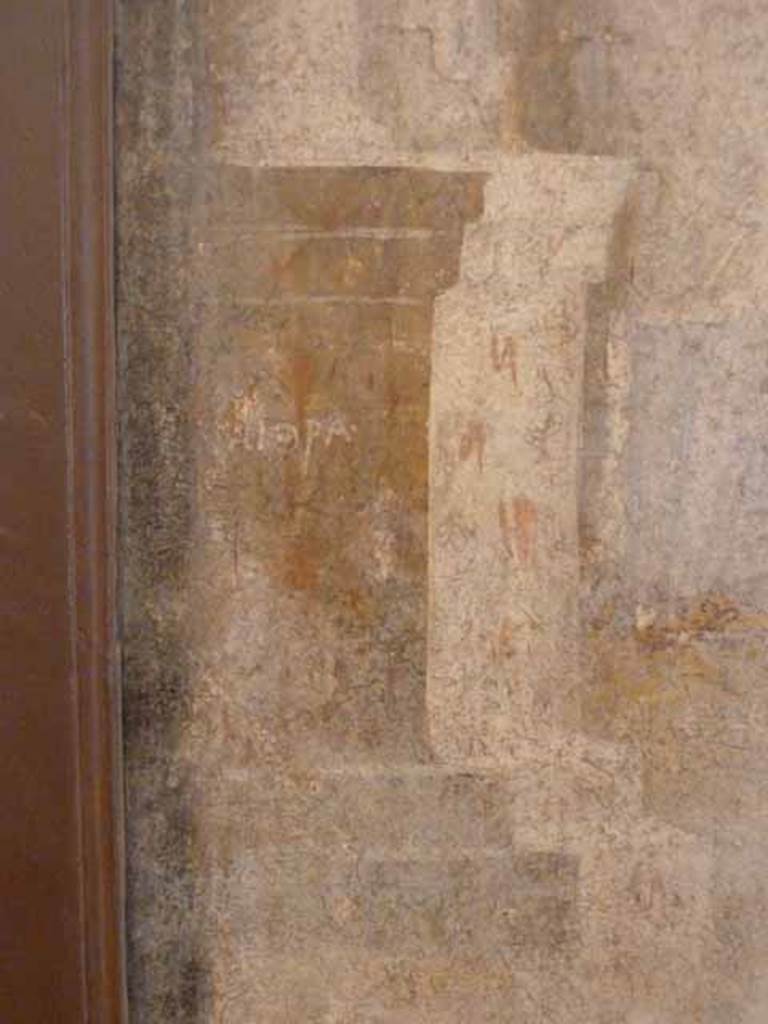I.2.6 Pompeii.  May 2010. Detail from the wall painting of the Theft of the Palladium (Ratto del Palladio) found on the south wall of the triclinium. Column base with name on left side of painting. Now in Naples Archaeology Museum, inventory number: 109751
