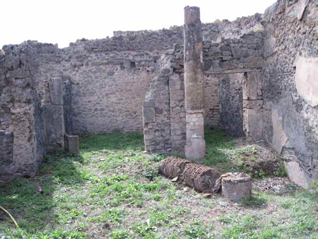 I.2.24 Pompeii. September 2010. Doorways to two rooms on west side of atrium, looking west. Photo courtesy of Drew Baker.
According to Fiorelli,  “after the entrance corridor there was an area, the roof held up by two columns, with an aperture through which the water flowed to an impluvium”. These would be the two columns that held up the roof, and the square “pool” against the north wall, the impluvium.

