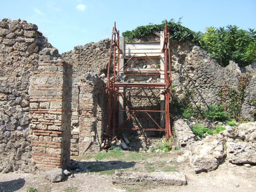 I.2.31 Pompeii. September 2005.  Looking north into rear room of caupona at 1.2.1, with the remains of entrance cill or doorway.  Painted near to the entrance on the brick construction, according to Fiorelli, was -     
CELSVMAED
      O.V.F
See Pappalardo, U., 2001. La Descrizione di Pompei per Giuseppe Fiorelli (1875). Napoli: Massa Editore. (p.34)

