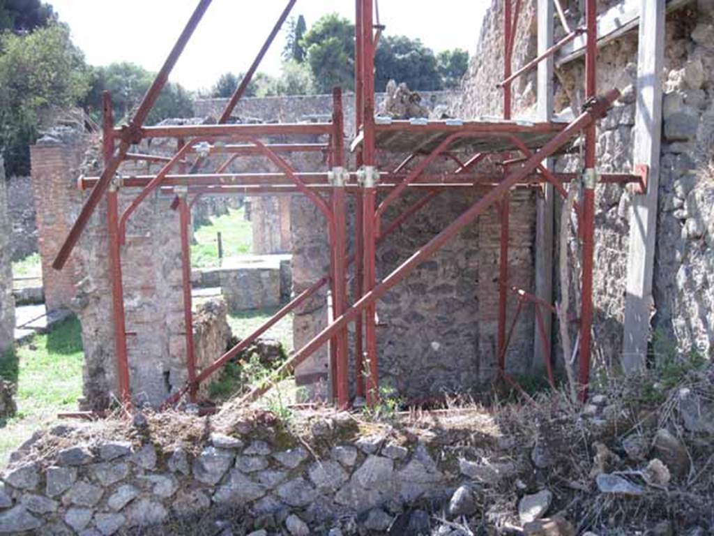 I.2.31 Pompeii. September 2010. West wall, with two doorways leading from two separate rear rooms into the main bar-room. Photo courtesy of Drew Baker.
