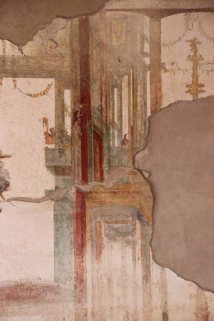 I.7.11 Pompeii. September 2021. 
Detail of painted decoration on west wall towards south end of triclinium. Photo courtesy of Klaus Heese.
