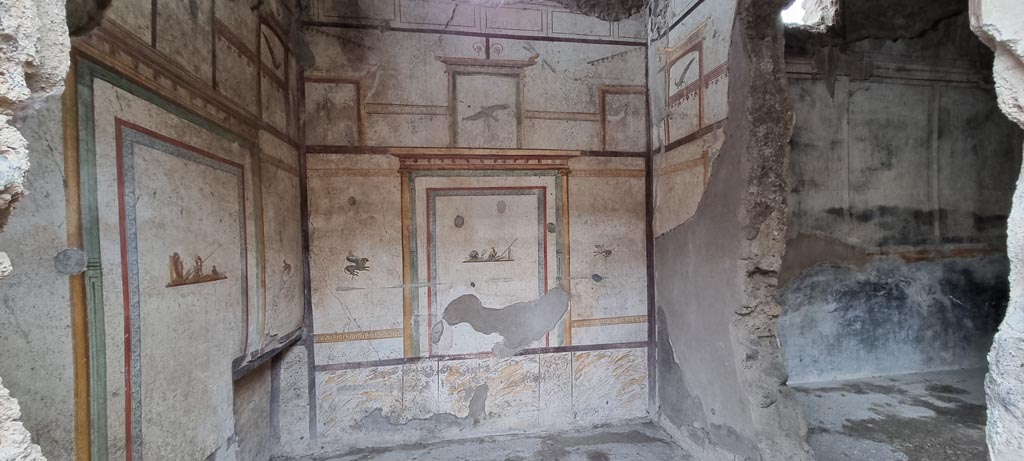 I.7.11 Pompeii. December 2023. Looking towards east wall, and south wall with hole into triclinium. Photo courtesy of Miriam Colomer.