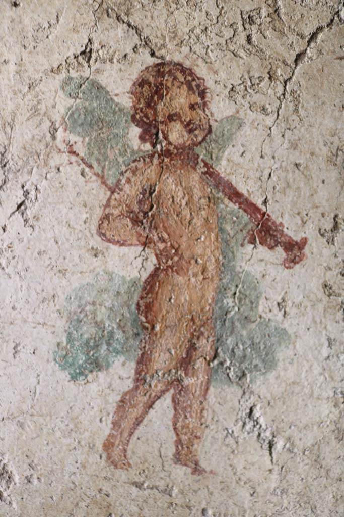 I.7.11 Pompeii. December 2018. 
Detail of wall painting of cupid with sword from south wall of bedroom on west side of atrium.
Photo courtesy of Aude Durand
