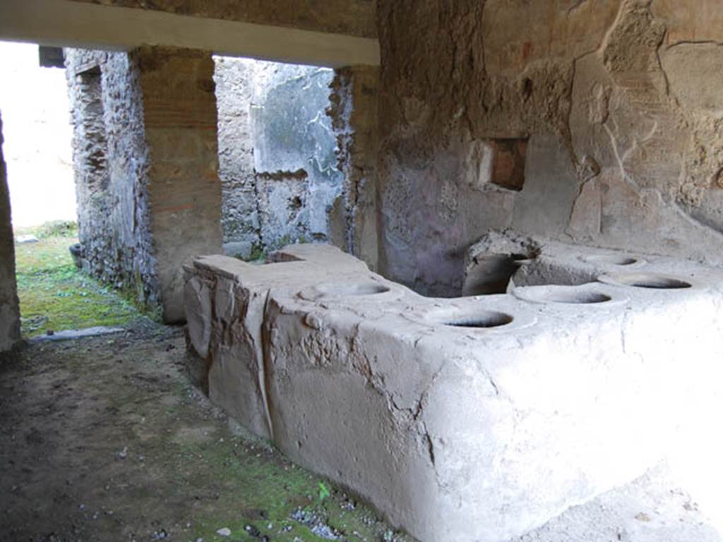 I.8.15 Pompeii. October 2013. 
Looking north-east towards podium in shop-room, and two rear rooms on its north side. Photo courtesy of Paula Lock.

