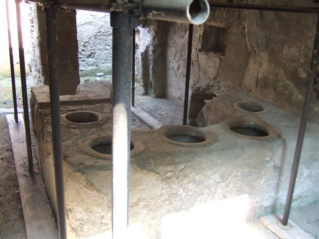 I.8.15 Pompeii. September 2005. Looking north across shop-counter towards rear rooms.  