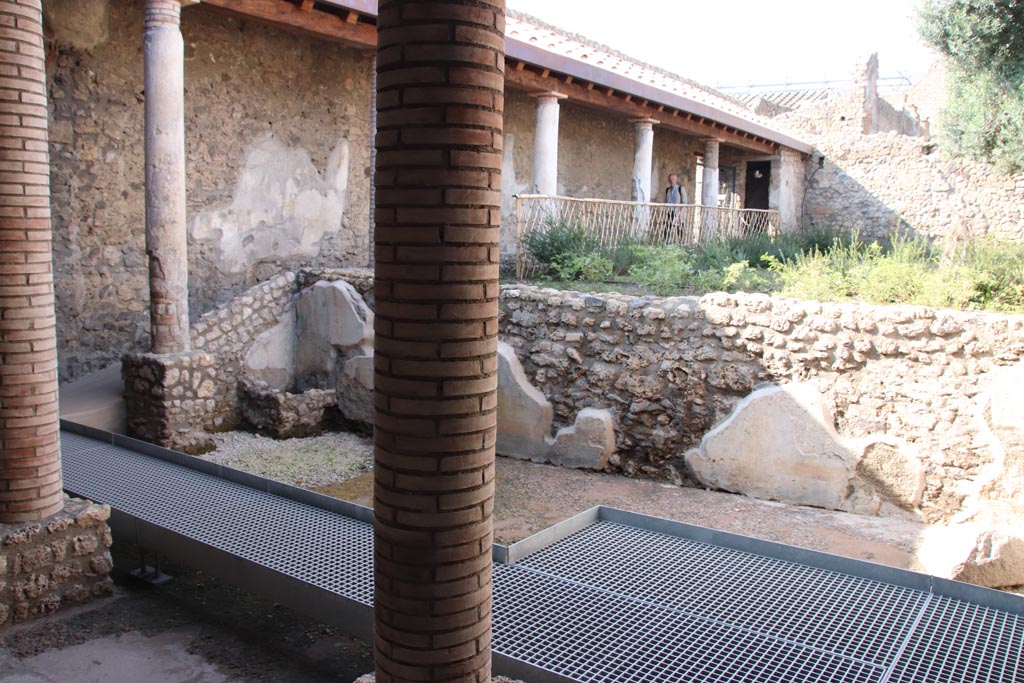 I.9.14 Pompeii. October 2022. 
Room 2, looking north-west across lower garden area with remains of painted wall.  Photo courtesy of Klaus Heese.
