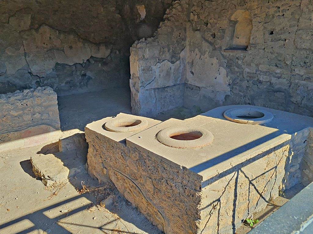 I.14.15 Pompeii. October 2024. Looking north-east across counter towards rear room. Photo courtesy of Giuseppe Ciaramella.