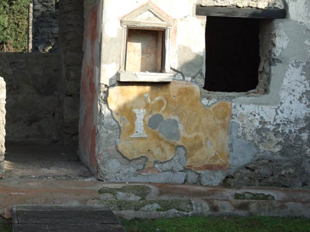 II.1.9 Pompeii. December 2007. Lararium.  Between the niche and the window was a painting of Hercules standing with his club, now faded or missing.   
See Frhlich, T., 1991, Lararien und Fassadenbilder in den Vesuvstdten.  Mainz: von Zabern.  (L39, p.265, T. 29, 4).
See Rivista di Study Pompeiani, X, 1999, Un ensemble de pots  peinture  Pompi, by Barbet, Tuffreau-Libre, Coupry. (p.71-81). SAP photo of lararium upon excavation, and a drawing of it by Barbet, can be seen on pages 74 and 75.
