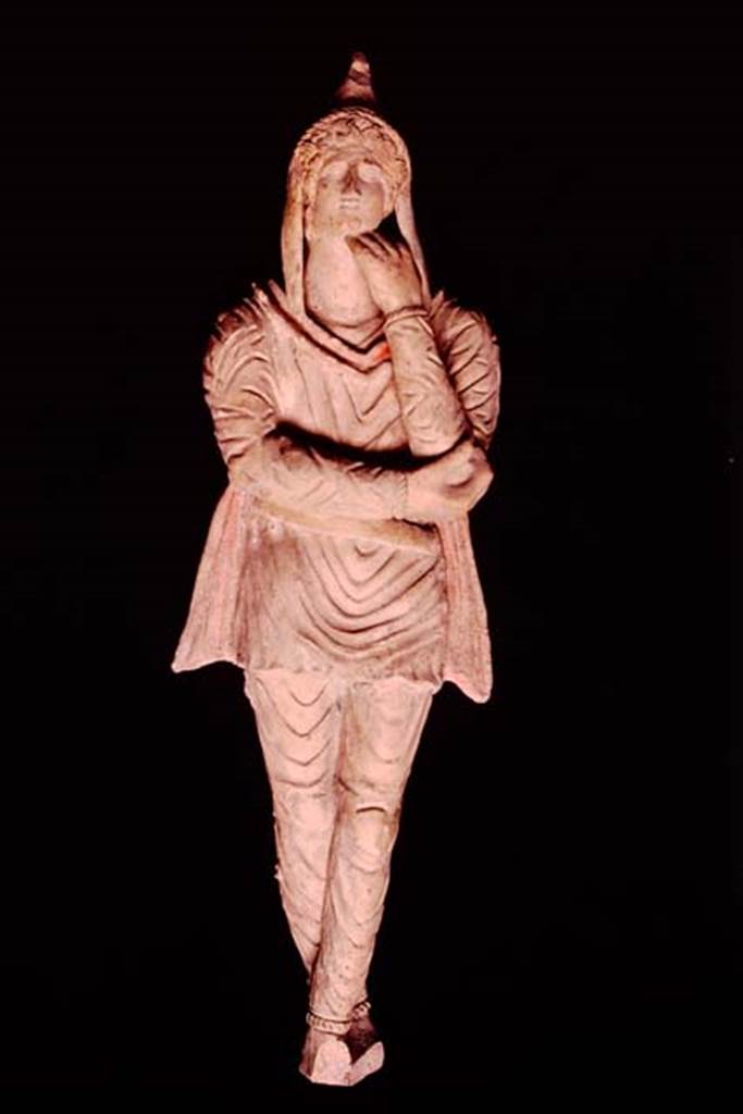 Pompeii, 1982 or 1983. Terracotta statuette of Attis discovered in the area next to the wall of the ancient well.   
This is the first of two statuettes found. SAP inventory number 10309.
Source: The Wilhelmina and Stanley A. Jashemski archive in the University of Maryland Library, Special Collections (See collection page) and made available under the Creative Commons Attribution-Non Commercial License v.4. See Licence and use details.
J80f0498
See DAmbrosio A. and Borriello M., 1990. Le terrecotte figurate di Pompei: SAP cat. 4. Roma: LErma di Bretschneider, p. 23, n. 16, Tav. V.
