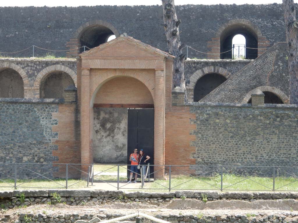 II.7.3, in centre, Pompeii. October 2022. Looking east across pool in palestra towards Amphitheatre. Photo courtesy of Klaus Heese