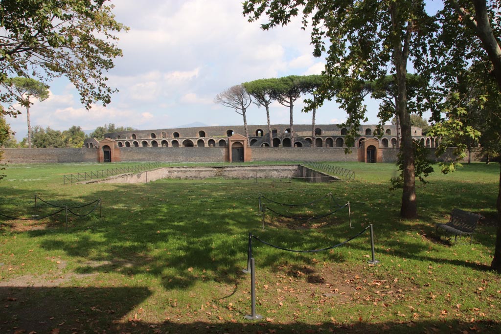 II.7.4 on left, 11.7.3 centre, II.7.2, on right. Pompeii. June 2019. Looking east across pool in palestra from doorway at II.9.
Photo courtesy of Buzz Ferebee.

