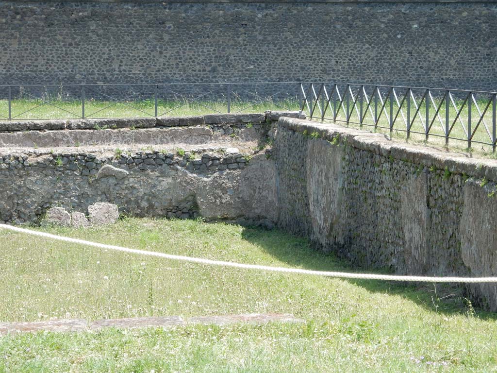 II.7 Pompeii. June 2019. Detail of edging in south-east corner. Photo courtesy of Buzz Ferebee
From here came the overflow that cleansed the latrine.
According to NdS in 1939, "Water channelling systems can also be seen in Pompeii in the large latrine of the private Gymnasium building in Via delle Scuole, and in the latrines of the Villa of the Mysteries and elsewhere, but this one in the Amphitheatre Gymnasium is the first example in Pompeii of the rational use of a large cistern system for draining a public latrine".
See Notizie degli Scavi di Antichità, 1939, p. 192, note 4.
