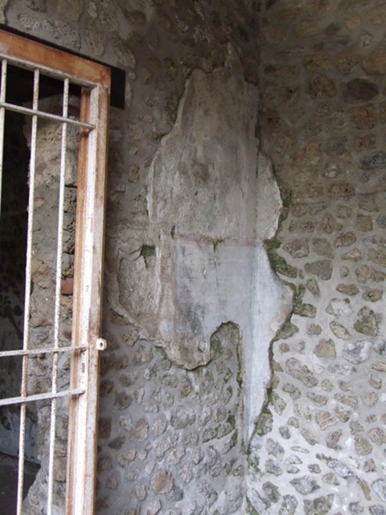 III.2.1 Pompeii.  March 2009.  North east corner of east portico, next to door to Room 14.