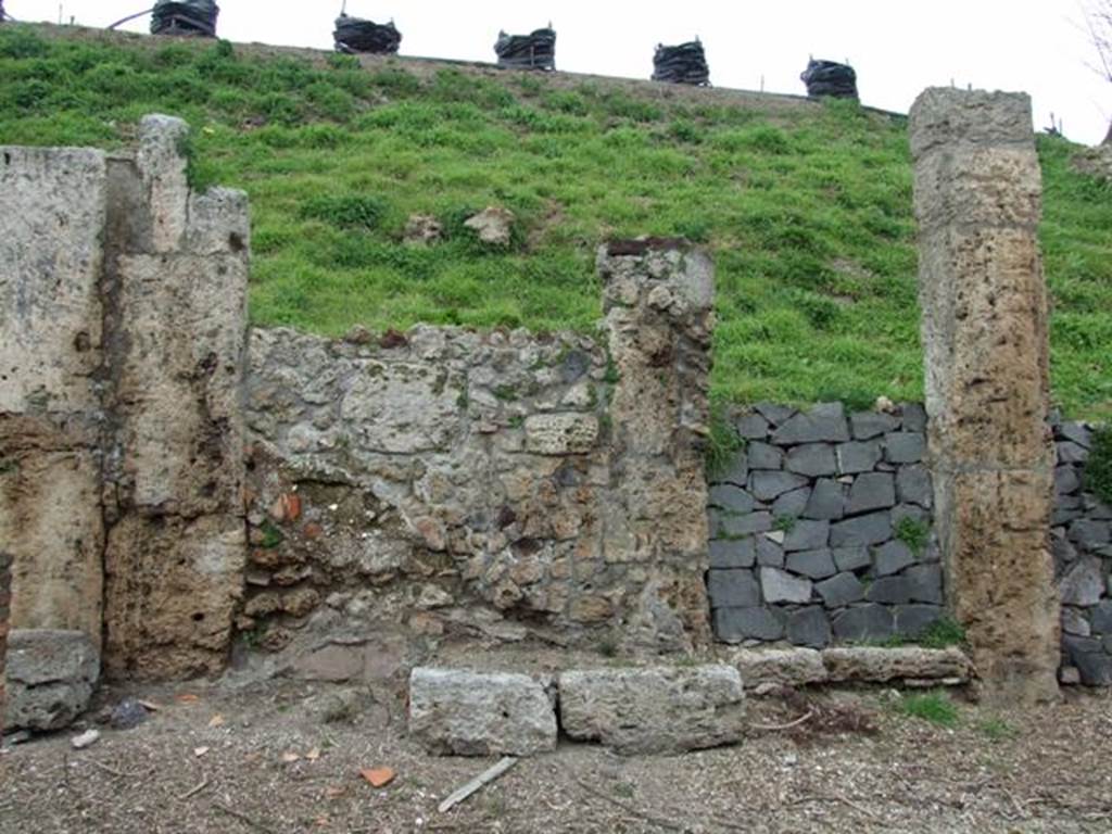 IV.2.b Pompeii. March 2009. Entrance doorway, with remains of a bench on the west side of it. According to Sogliano, this doorway noted for its square blocks of Sarno stones led to an entrance corridor flanked by two cubicula. The one on the right was decorated with beautiful stucco. Found there on 27th December 1902 were the remains of a human skeleton. Found on 29th December 1902 was a terracotta lamp decorated with a tragic mask. See Notizie degli Scavi di Antichit, 1905, (p.280). According to CTP, it was definitely the house at b with the two cubicula near its entrance that was mentioned by Sogliano. See Van der Poel, H. B., 1986. Corpus Topographicum Pompeianum, Part IIIA. Austin: University of Texas. (p.68). According to Luongo et al, the skeleton was found to the right of the entrance in House d. See G. Luongo et al: Impact of the AD79 explosive eruption on Pompeii, in Journal of Volcanology & Geothermal Research 126 (2003) (p.185).