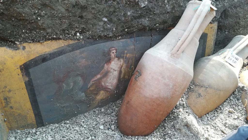 V.3 Pompeii. March 2019. Thermopolium at the crossroads between Vicolo delle Nozze d’Argento and Vicolo dei Balconi. 
Amphorae located in front of the painting of a Nereid on the counter, during excavation.

V.3 Pompei. Marzo 2019. Termopolio all'incrocio tra il Vicolo delle Nozze d'Argento e il Vicolo dei Balconi.
Anfore situate di fronte al dipinto di una Nereide sul bancone, durante gli scavi.

Photograph © of Parco Archeologico di Pompei.
