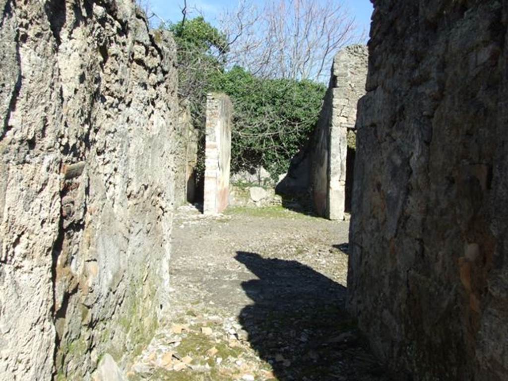 V.4.c Pompeii. March 2009. Looking east across room A, the fauces, towards atrium and tablinum.
According to NdS, (1902) 
In the house in Reg. V that had its doorway opposite to the one at V.3.11 (therefore V.4.c), I verify that on the 1st May, an important discovery was made of 4 skeletons with the following objects 
Large gold bracelet in the shape of facing serpents;
Two gold rings set with stone;
A pair of earrings;
One aureus of Nero, and two of Domitian;
29 silver coins, silver bronze mirror

The death of the unfortunates would have seemed to have been from the fire that caused the floor of the upper room, where they had taken refuge, to collapse, and whose violence had partly burnt their bones and left traces on the paintings on the walls.

The house, to judge from the part excavated up until now, will not have been very large, nor as beautiful as the one opposite to it (V.3.11). 
However, it had in the tablinum fairly good paintings showing the four seasons (Autumn completely disappeared, and in the atrium was a painting of Mercury with purse and staff/caduceus, very similar to the one existing in the thermopolium V.4.6-7 (see Notizie1899, p. 343) however, ours had a large serpent curled/tangled at his feet.
R.PARIBENI.
See Notizie degli Scavi, 1902, (p.276).
